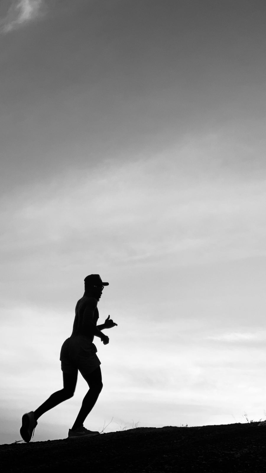 Runner silhouette at dusk, training for the Marine Corps PFT three-mile run