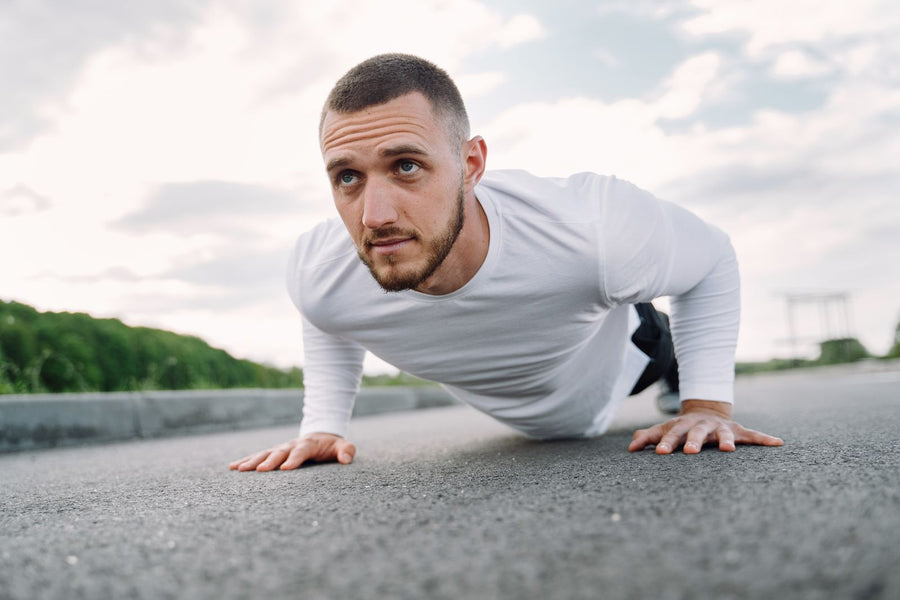 Sailor doing push-ups outdoors, training for the Navy PRT