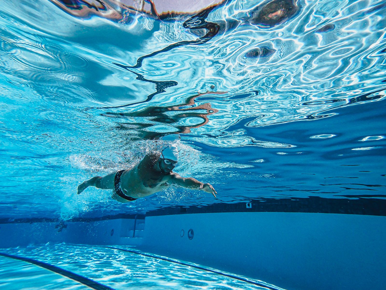 Swimmer doing laps in a pool, training for the Coast Guard fitness test cardio option