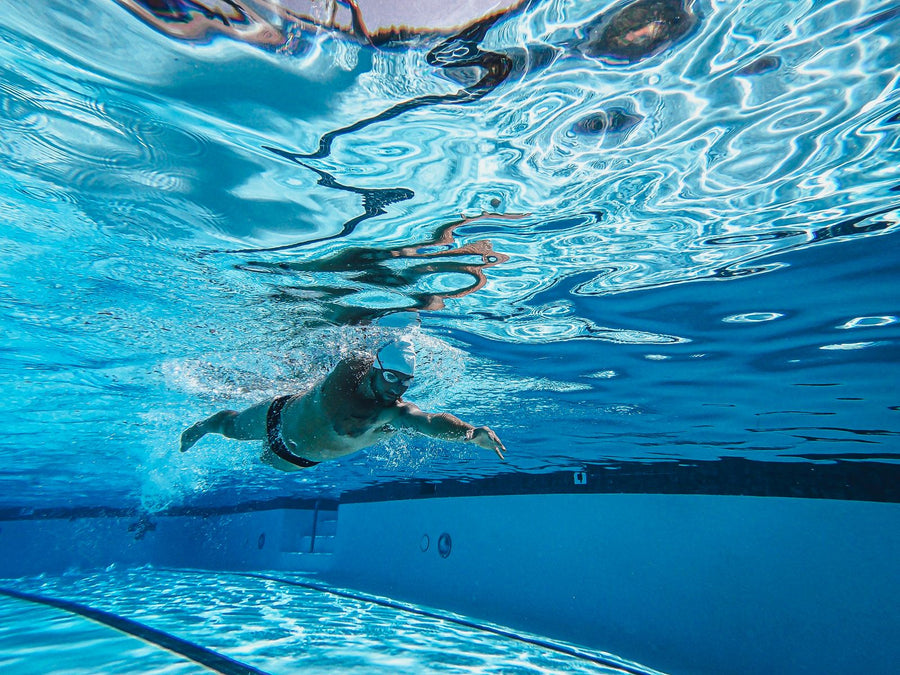 Swimmer doing laps in a pool, training for the Coast Guard fitness test cardio option